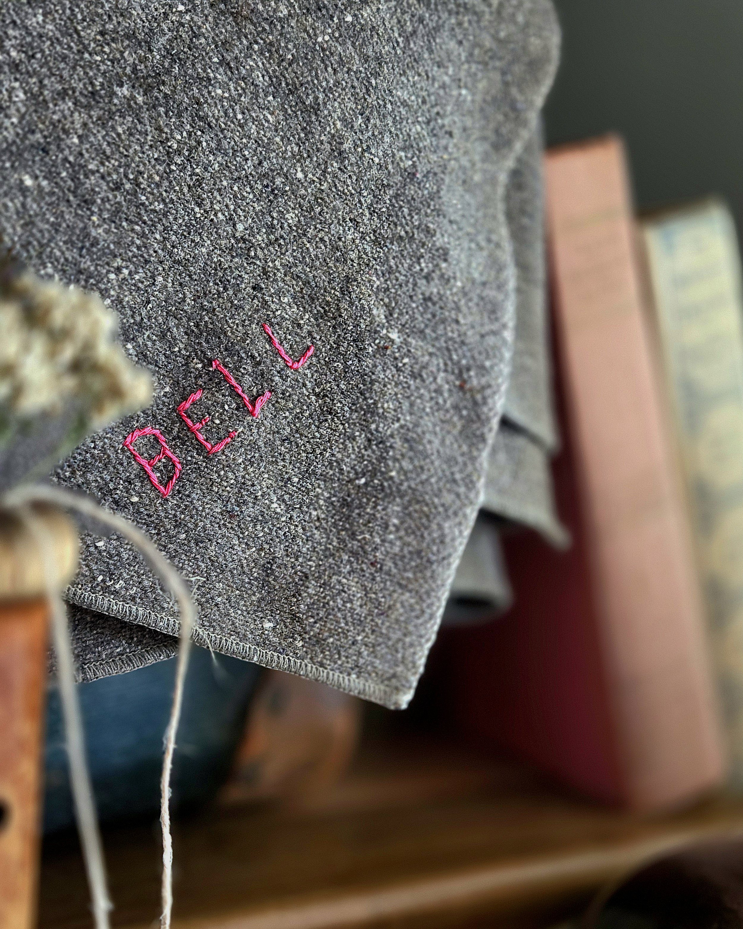 Embroidered surname on a wool camp blanket
