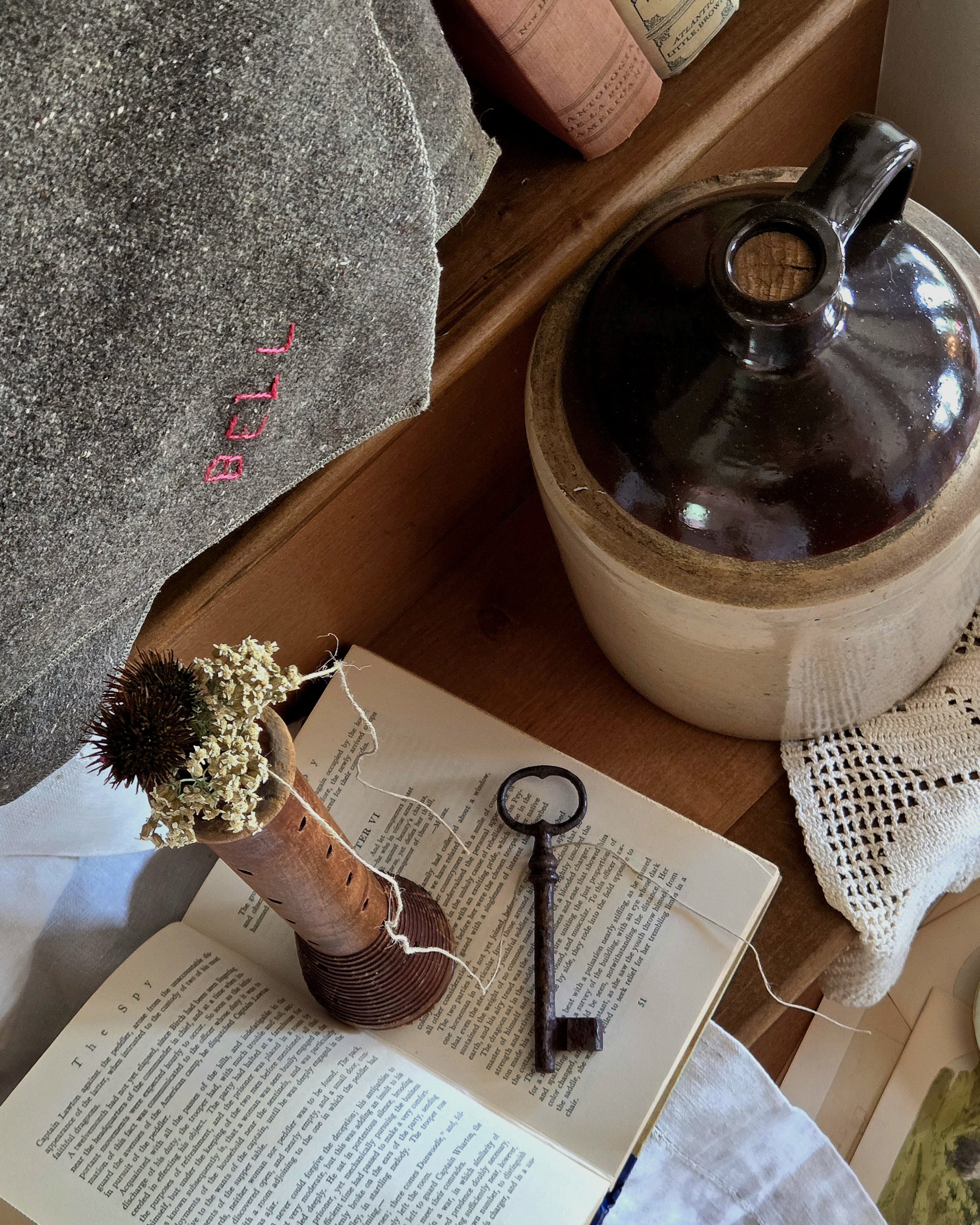 The stoneware water jug maintains its original cork
