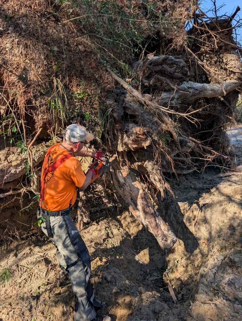 PAR volunteer uses chainsaw to cut tree after Hurricane Isaias damage
