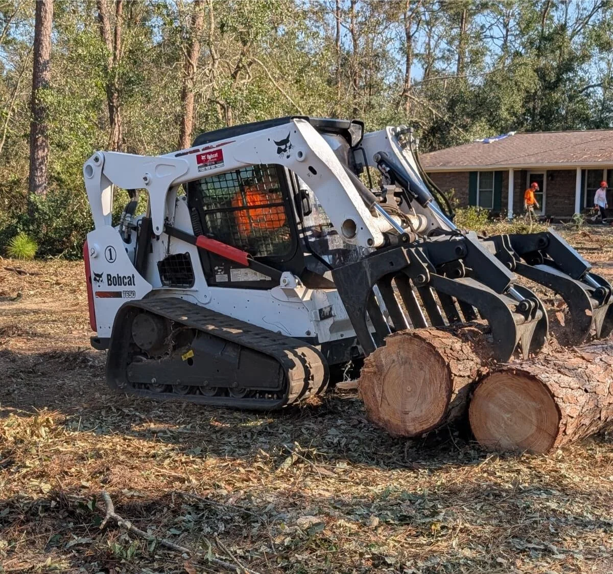 PAR skidsteer removes logs after hurricane damage