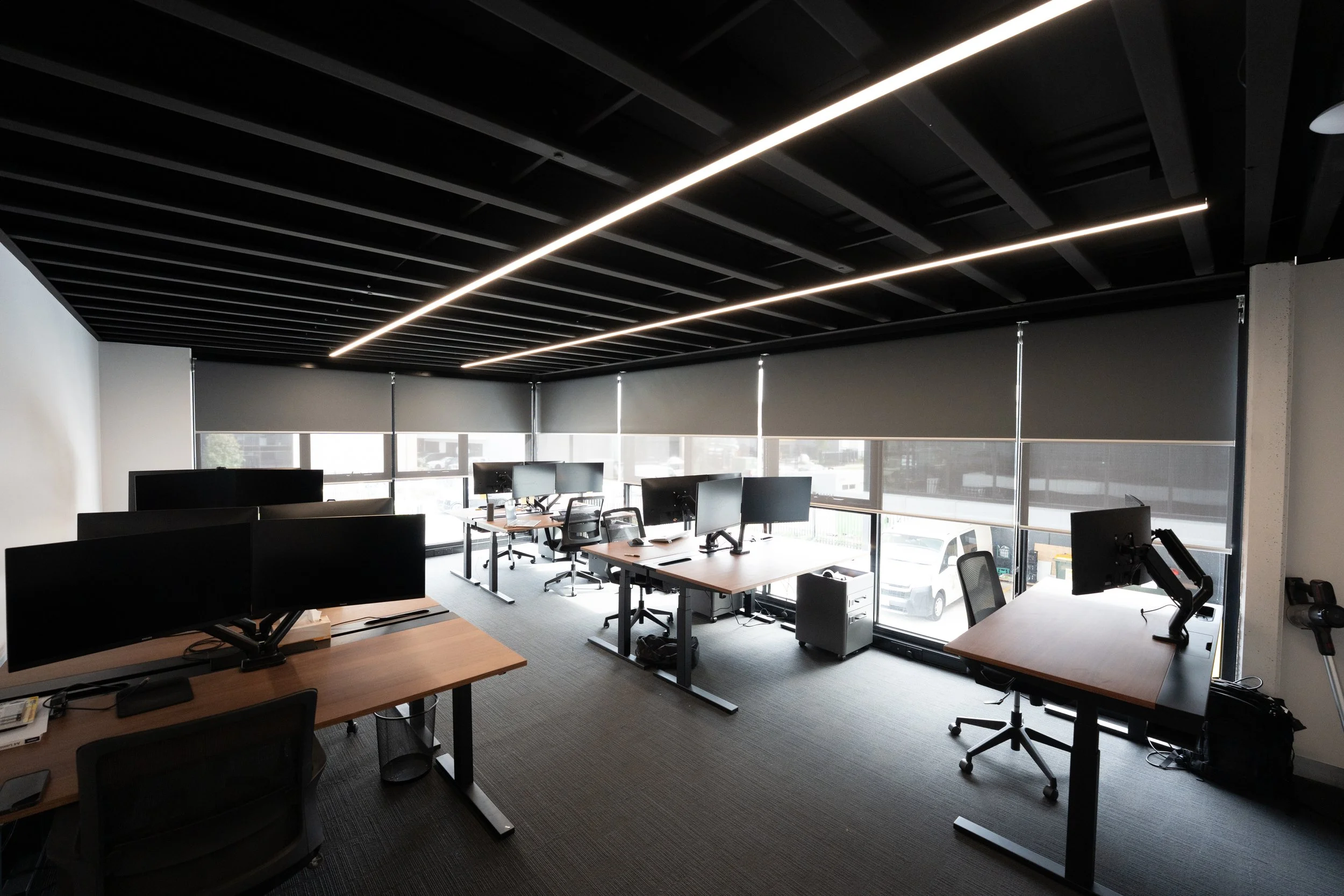 Open-plan office with roller blinds on the far windows