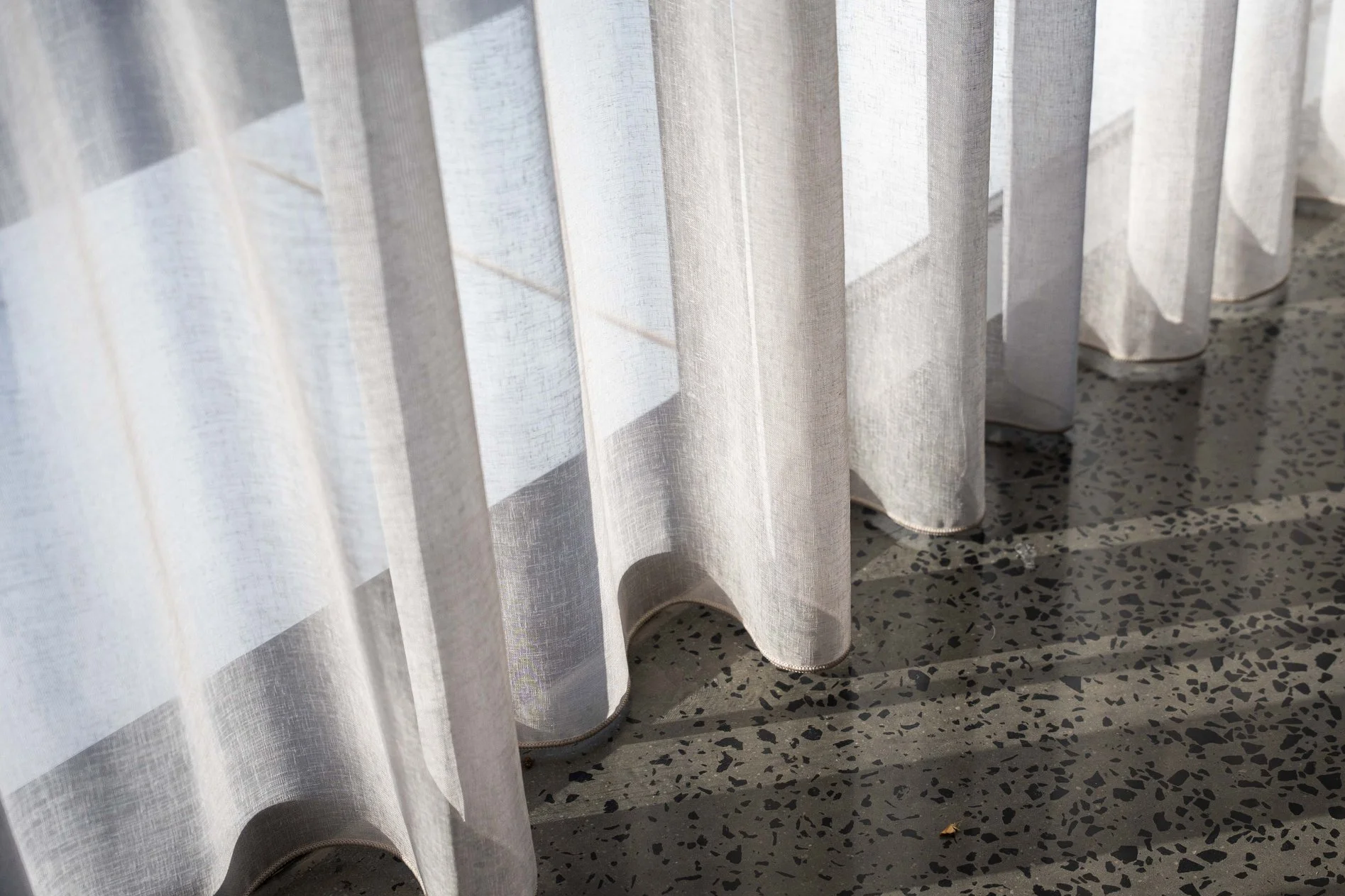 Sheer curtains falling in soft folds to the floor