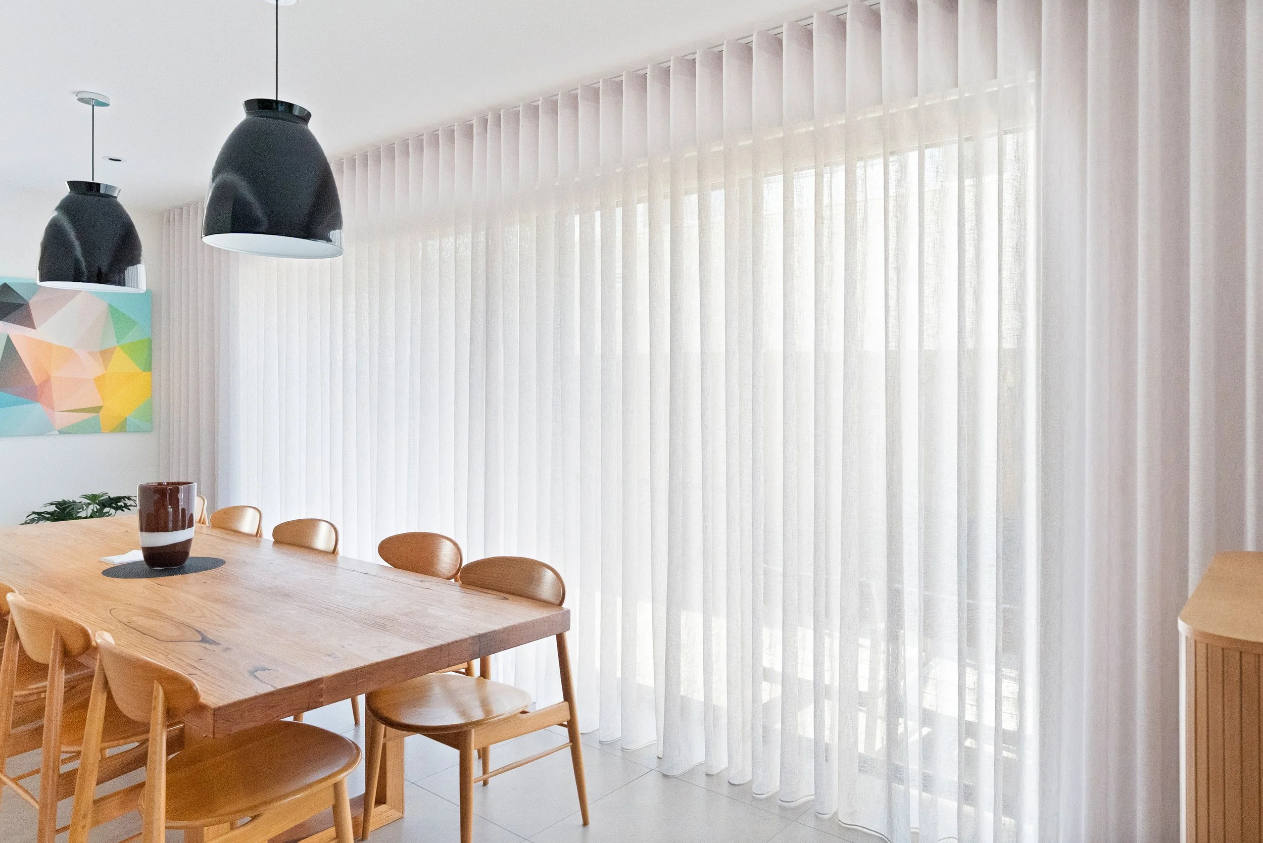 Sheer curtains closed across the full width of the dining room