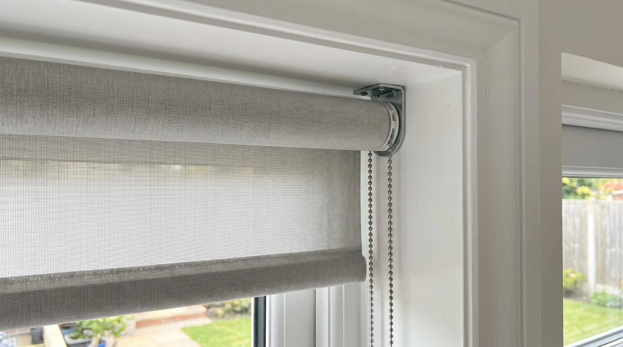 Recess-fit roller blind sitting inside the window reveal