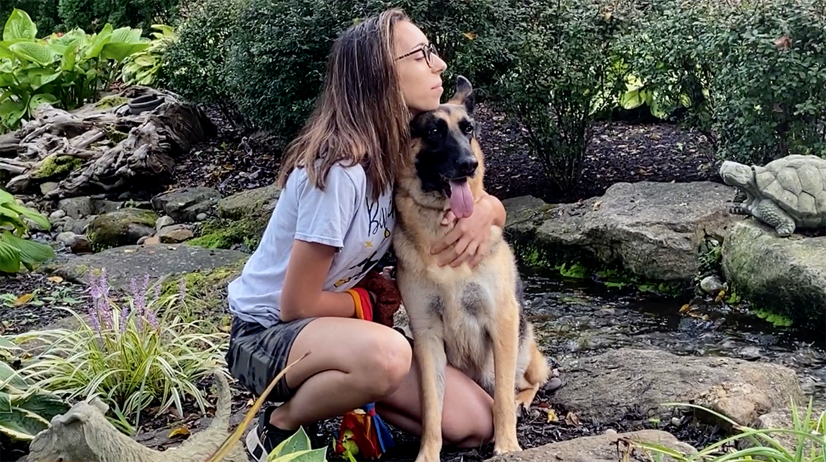 David Scott Weitz photographing a staff member outside with a German Shepherd at Janry Pet Resort