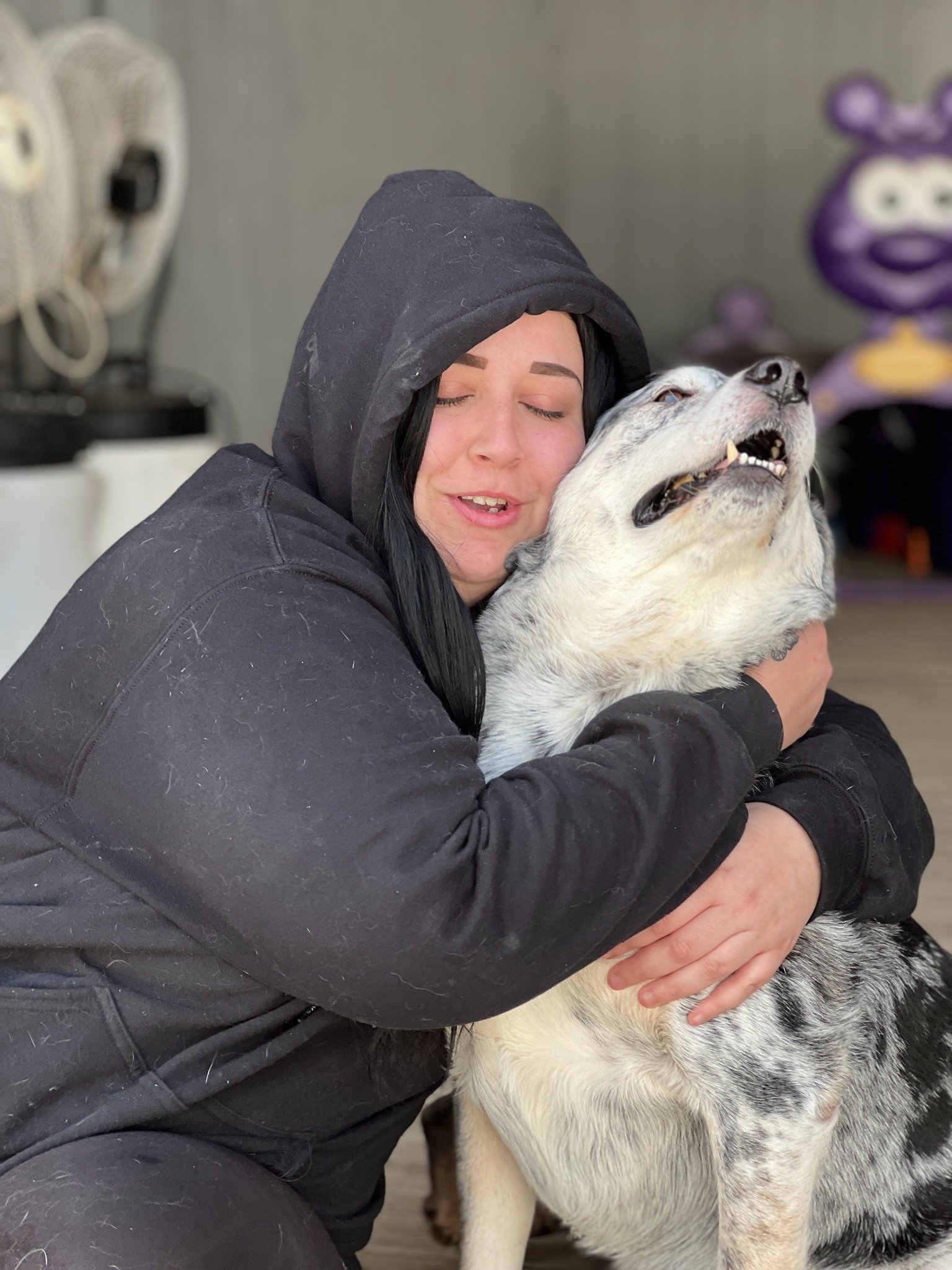 David Scott Weitz photographing a staff member with a dog at Janry Pet Resort 