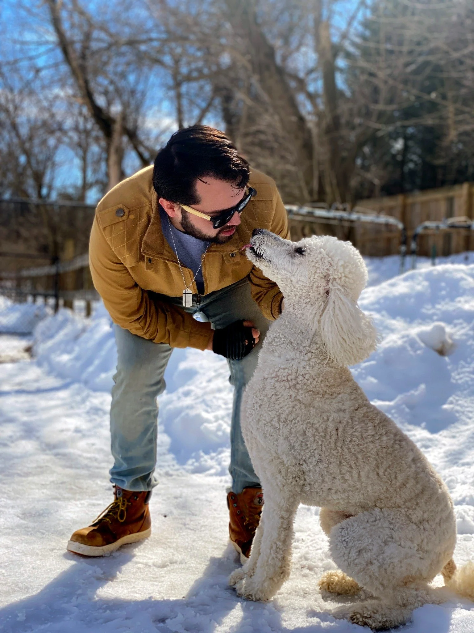 David Scott Weitz photographing a staff member outside with a dog at Janry Pet Resort 