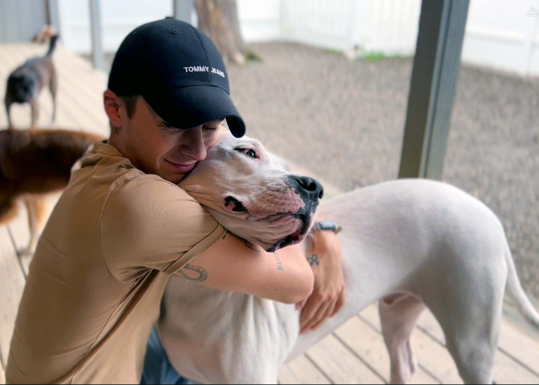 David Scott Weitz photographing a staff member outside with a dog at Janry Pet Resort