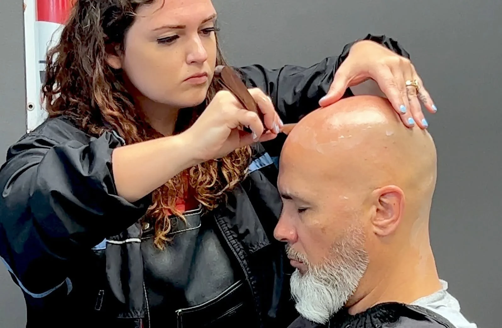 David Scott Weitz photographing a female barber at Players Barber Shop in Hatboro, Pennsylvania
