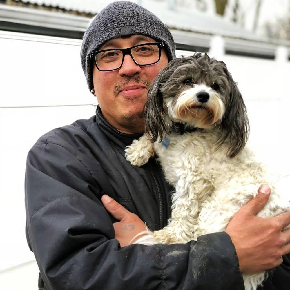 David Scott Weitz photographing a staff member outside with a dog at Janry Pet Resort 