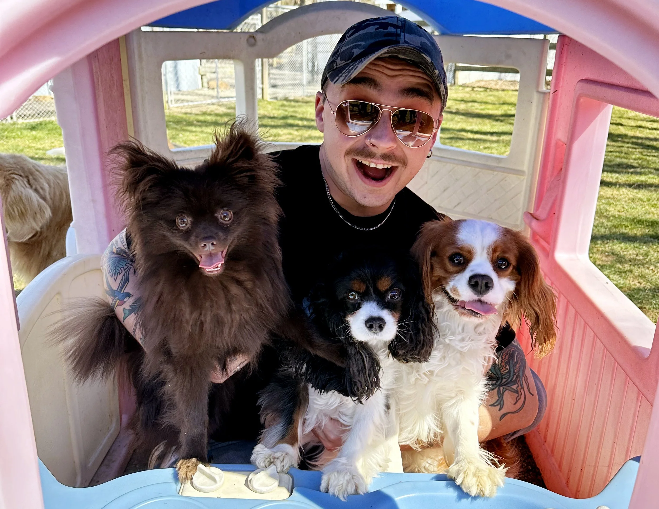David Scott Weitz photographing a staff member outside with three dog's at Janry Pet Resort