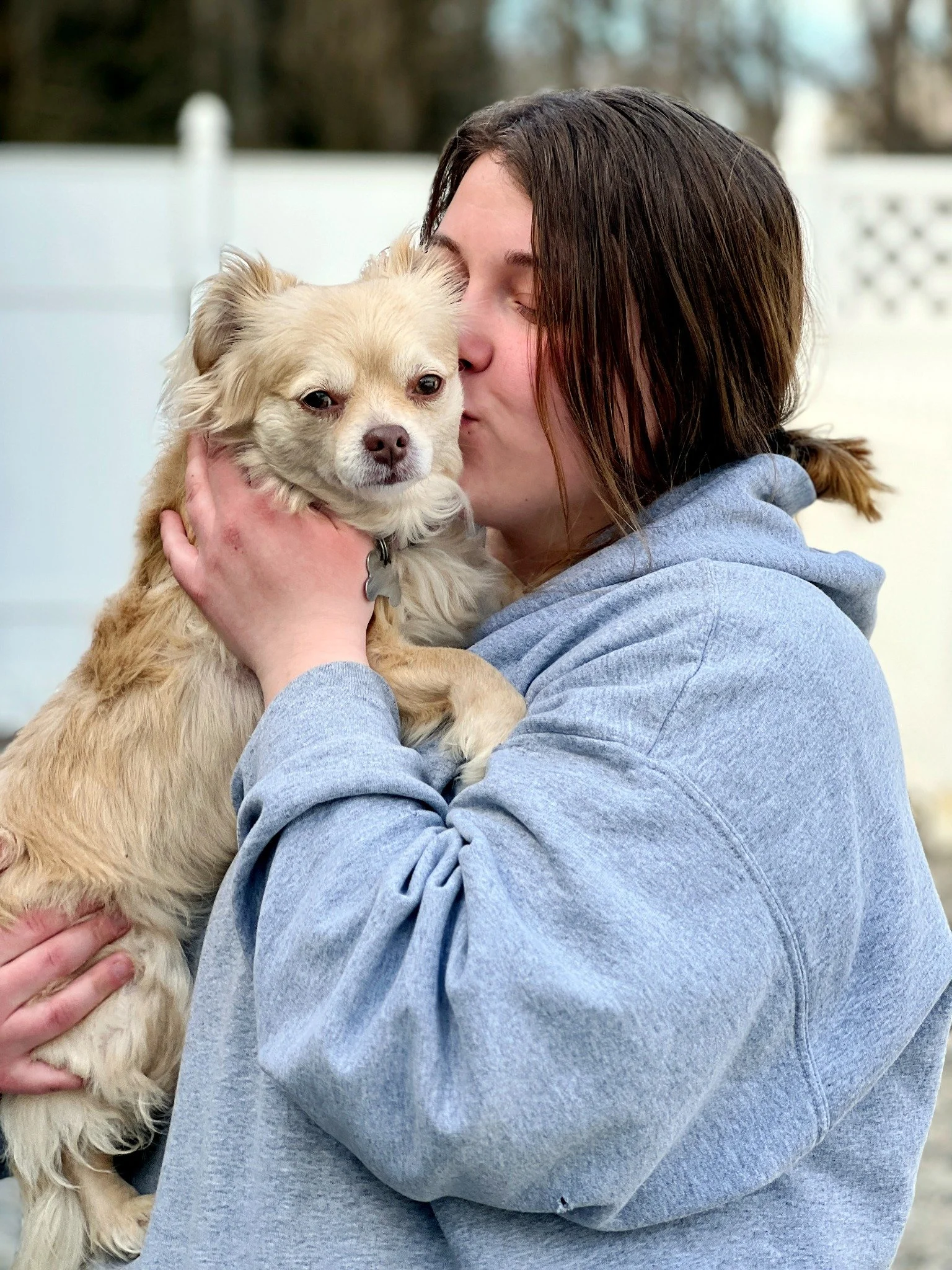 David Scott Weitz photographing a staff member outside with a dog at Janry Pet Resort 
