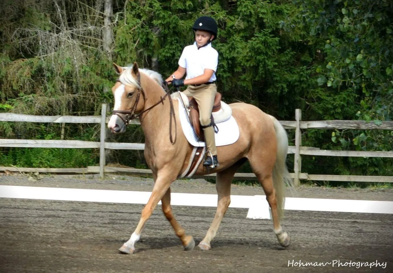 Young rider practicing in the arena at Shallow Creek Stables