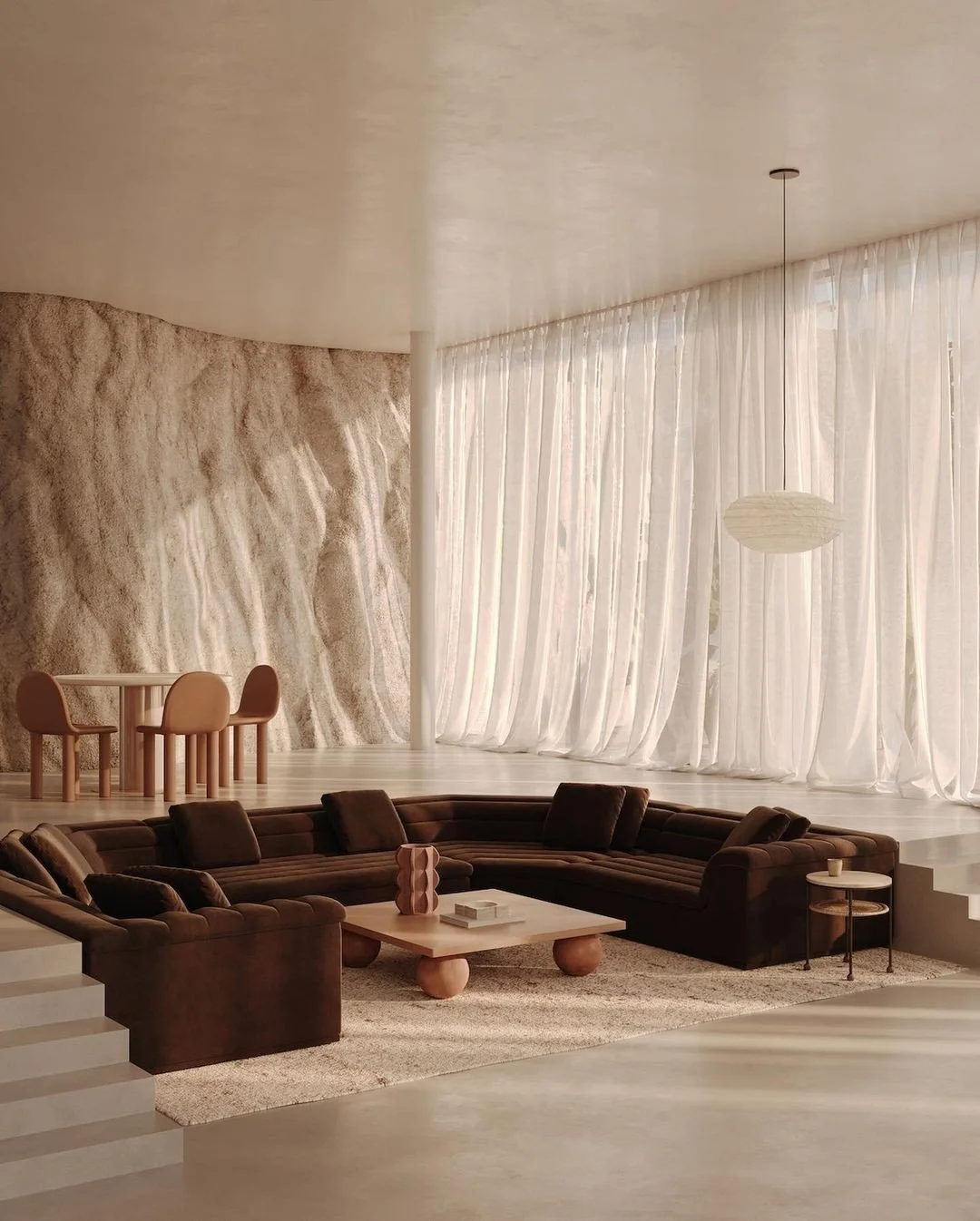 Modern living room with brown sectional sofa, beige rug, cream curtains, textured wall, round coffee table, and dining area with four chairs in the background.