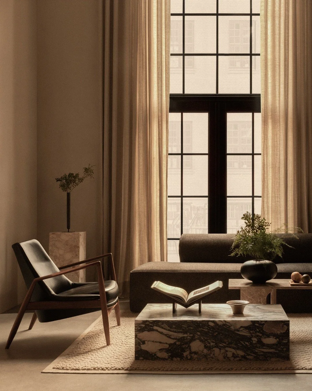 Living room with a large window, beige curtains, a black armchair, a beige sofa, a marble coffee table with an open book, a black vase with greenery, and decorative objects.