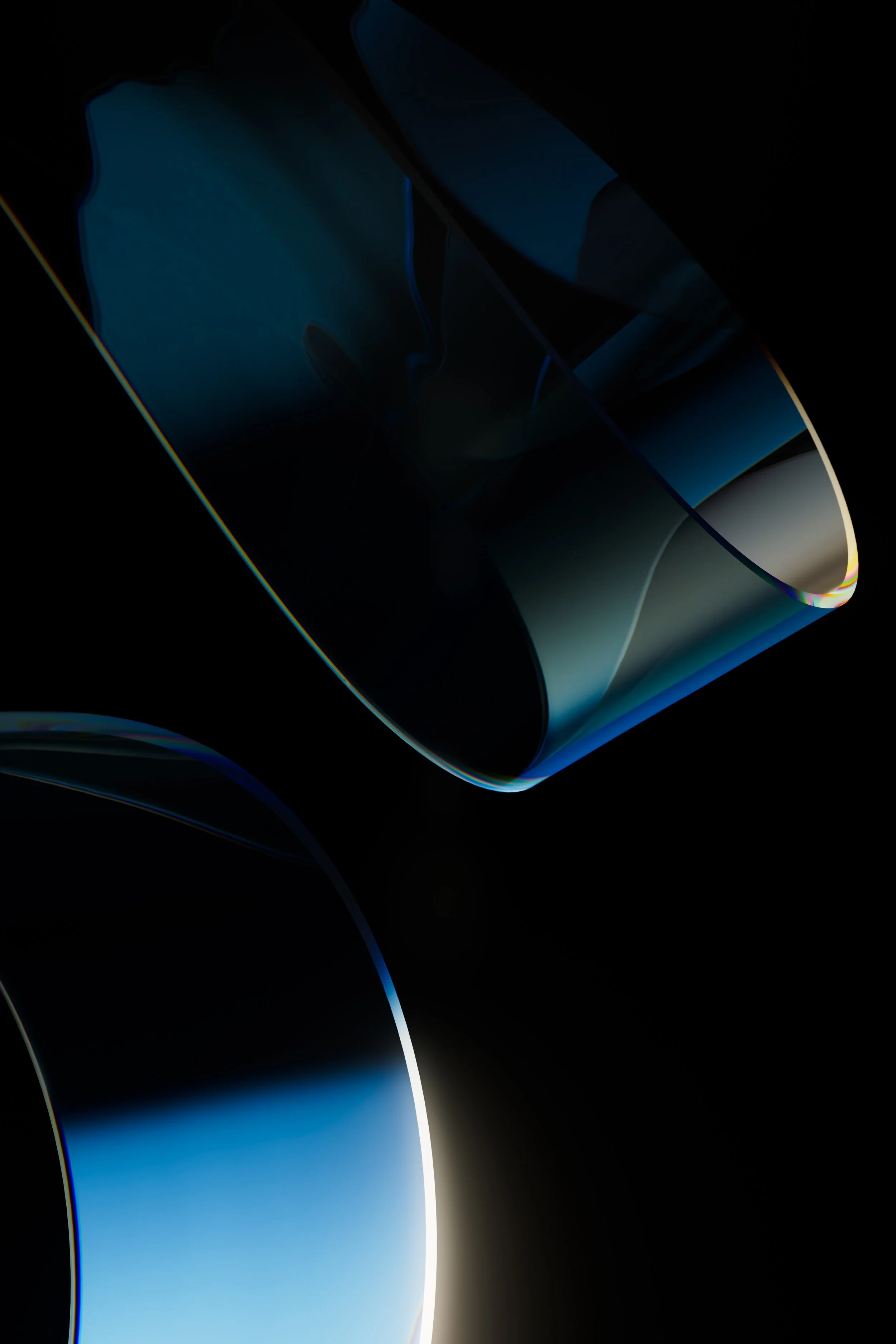 Close-up of a dark, reflective, curved glass surface with blue light reflections and edges illuminated by a soft glow.