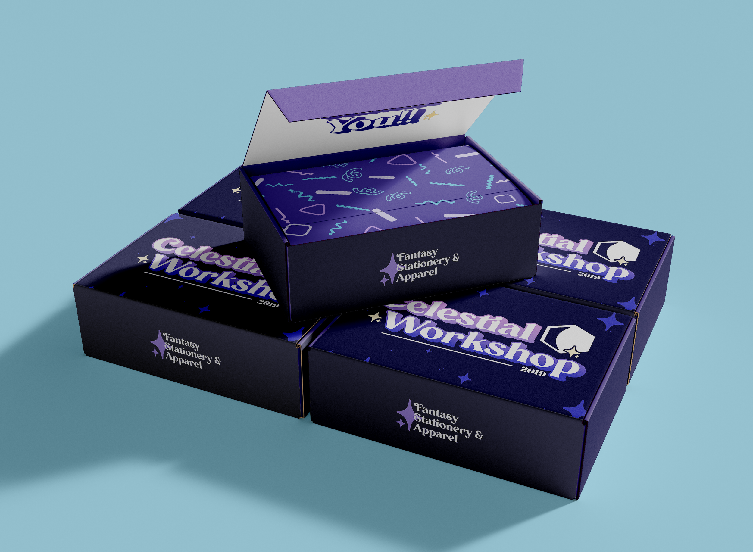 Open boxes labeled "Celestial Workshop" and "Fantasy Stationery & Apparel" with a colorful, starry pattern inside, on a light blue background.