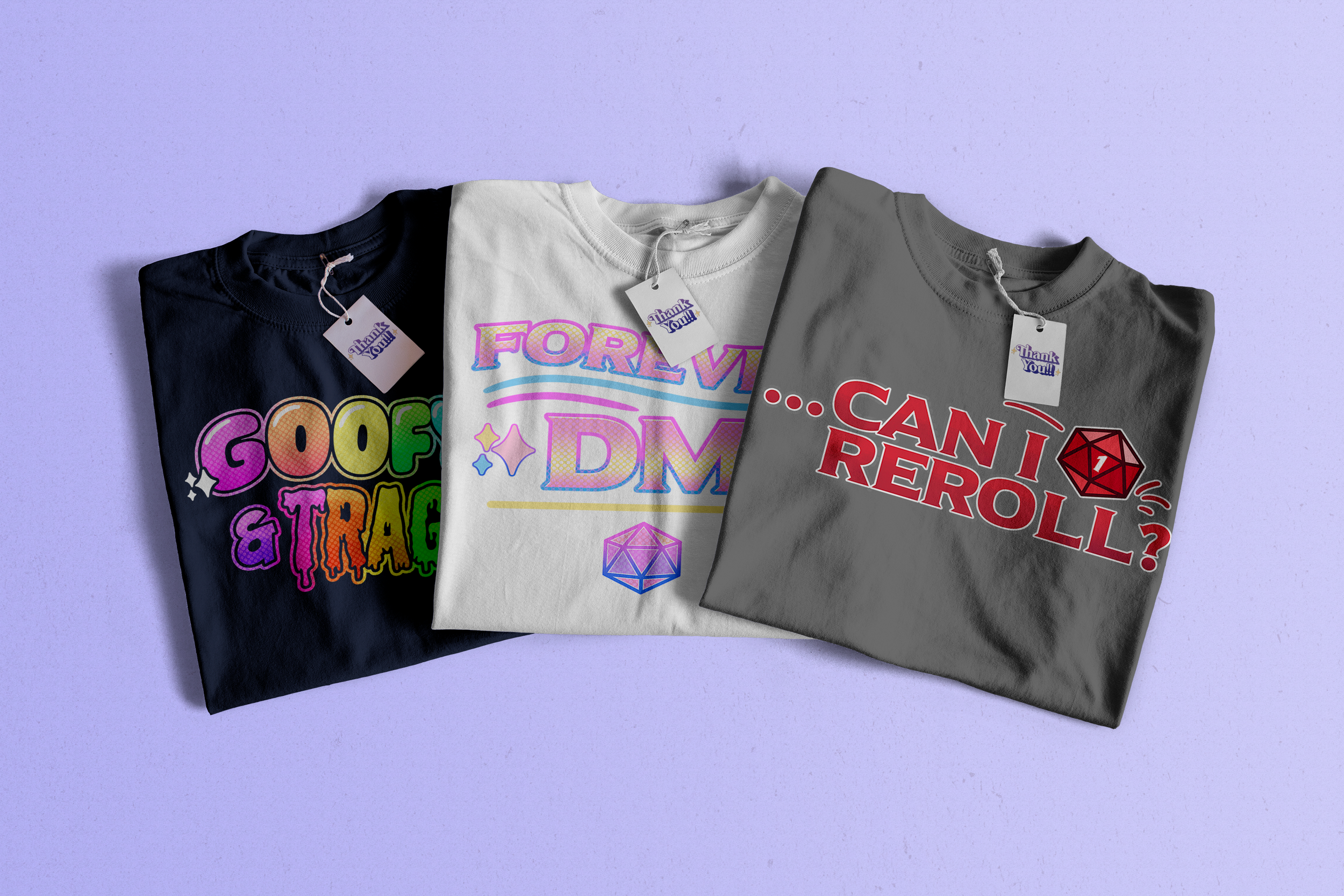 Three T-shirts with different graphic designs and messages laid flat on a purple background.