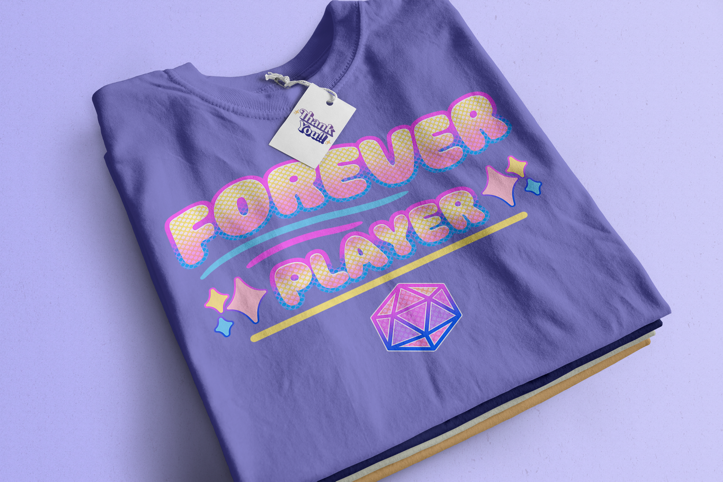 A purple folded T-shirt with colorful text reading 'FOREVER LAURA' and decorative stars, diamonds, and lines, with a 'Thank you!!' tag attached.