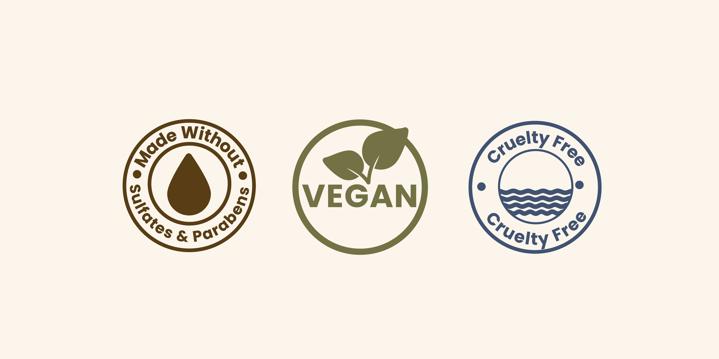 Three badges indicating product attributes. The left badge is brown with a droplet icon and says, 'Made Without Sulfates & Parabens.' The middle badge is green with a leaf and says, 'Vegan.' The right badge is blue with water waves and says, 'Cruelty Free'.