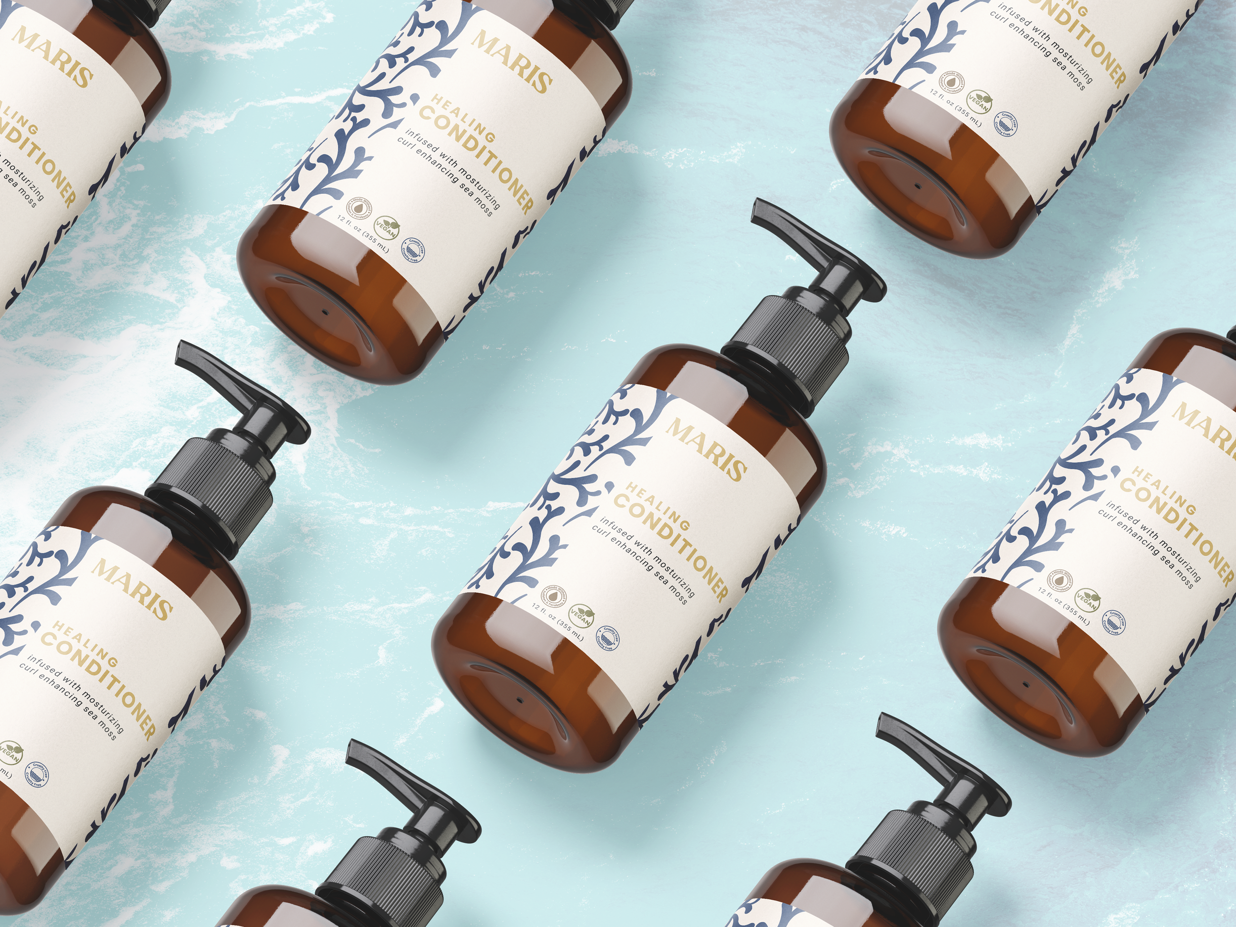 Multiple bottles of Maris Healing Conditioner scattered on a surface resembling ocean or sky with water texture.