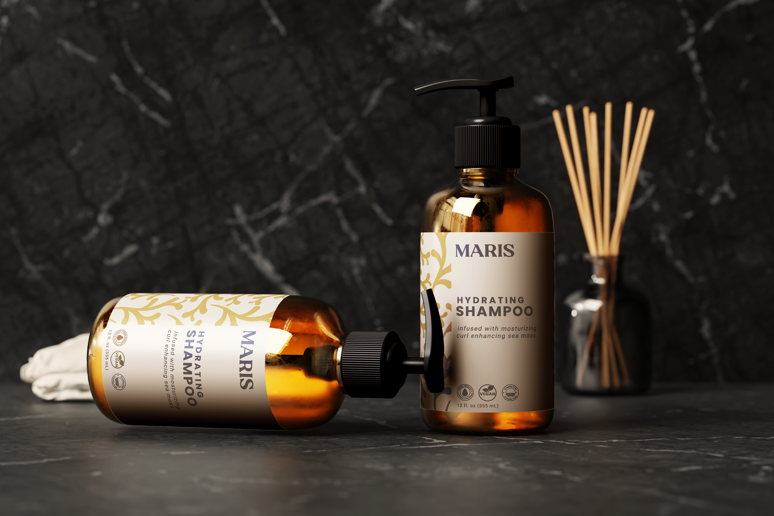 Two amber-colored bottles of Maris hydrating shampoo, one lying down and one standing, with black pump and cap, against a dark textured background, and a diffuser stick in the background.