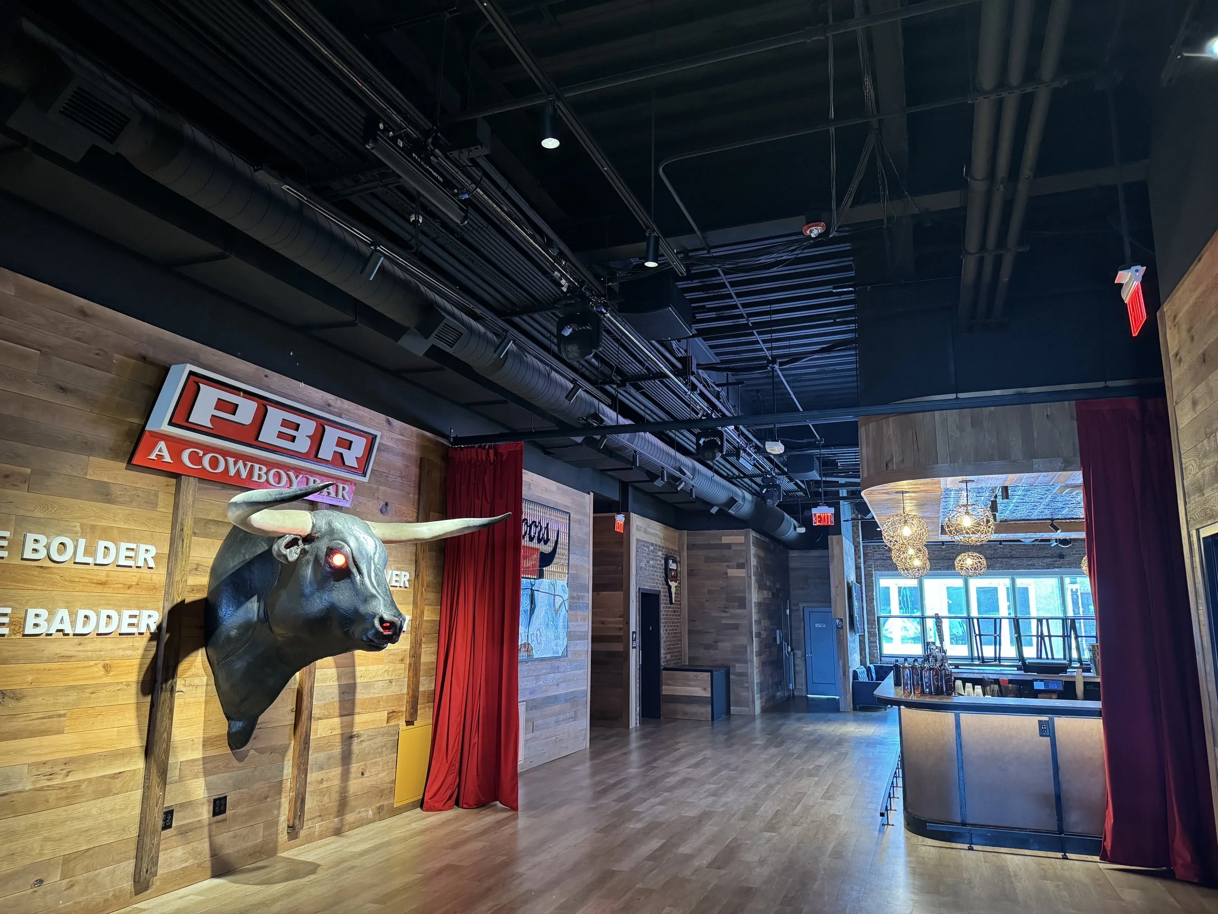 Interior of a restaurant with a custom red velvet curtain on a track system.