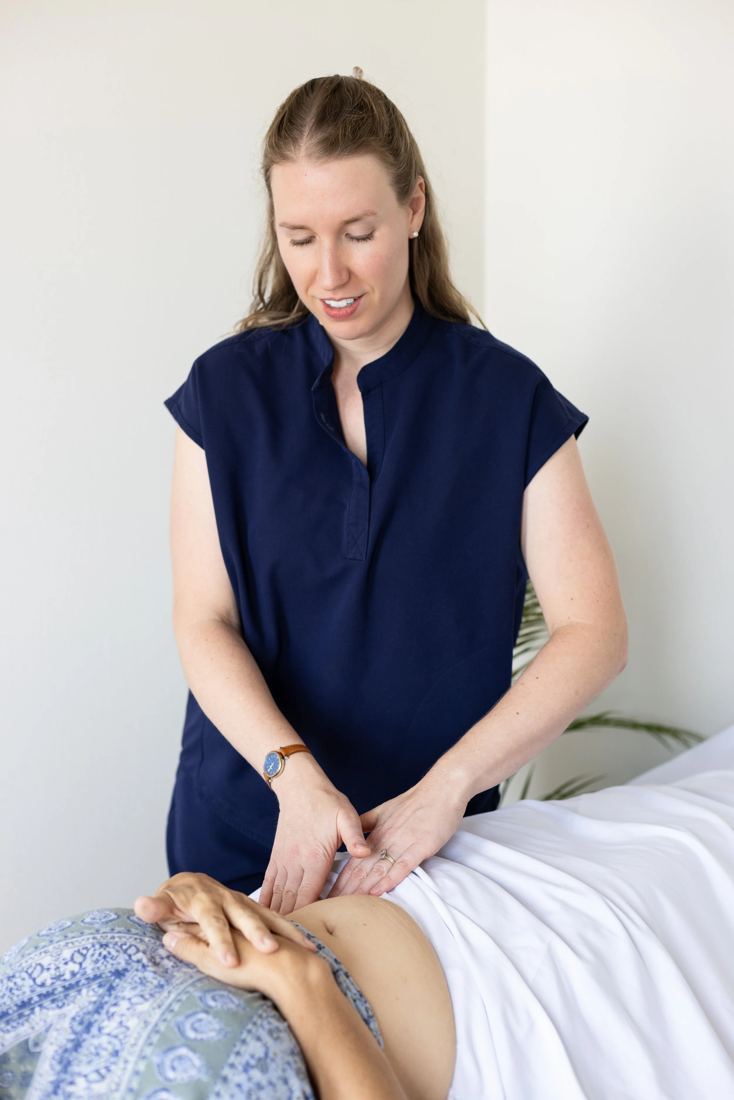 pelvic floor physical therapist performs bowel massage on a patient