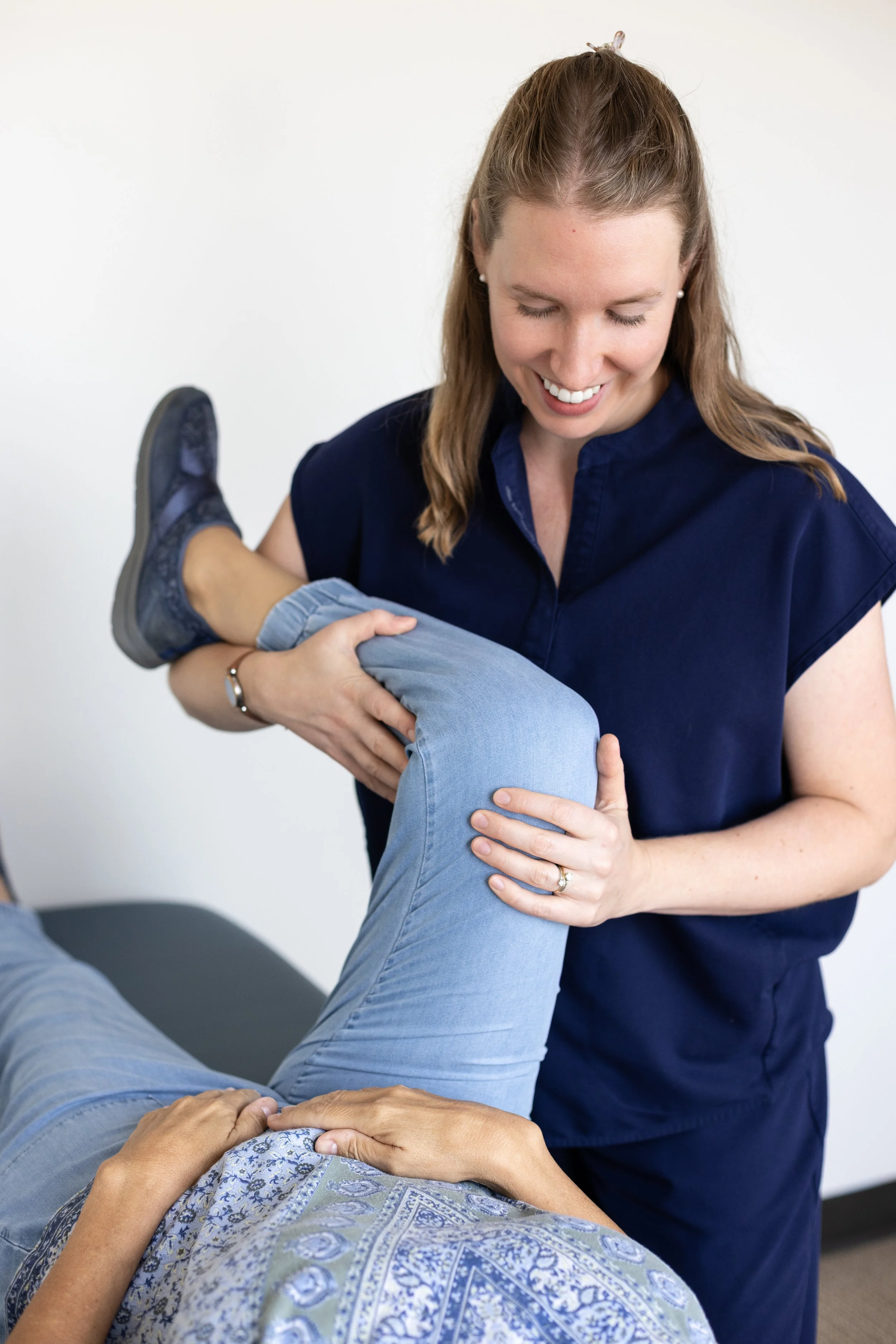 pelvic floor physical therapist treats a patient's hip