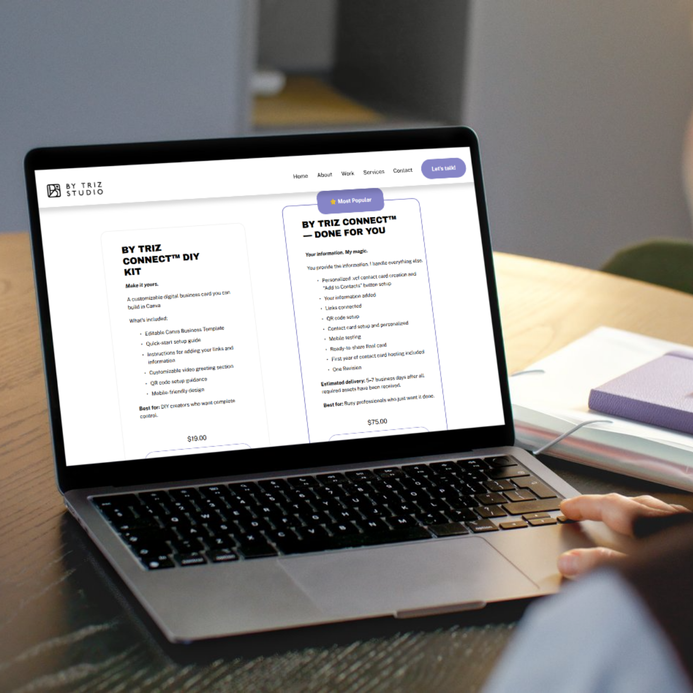 A person using a laptop on a desk, viewing a webpage with product descriptions and prices.