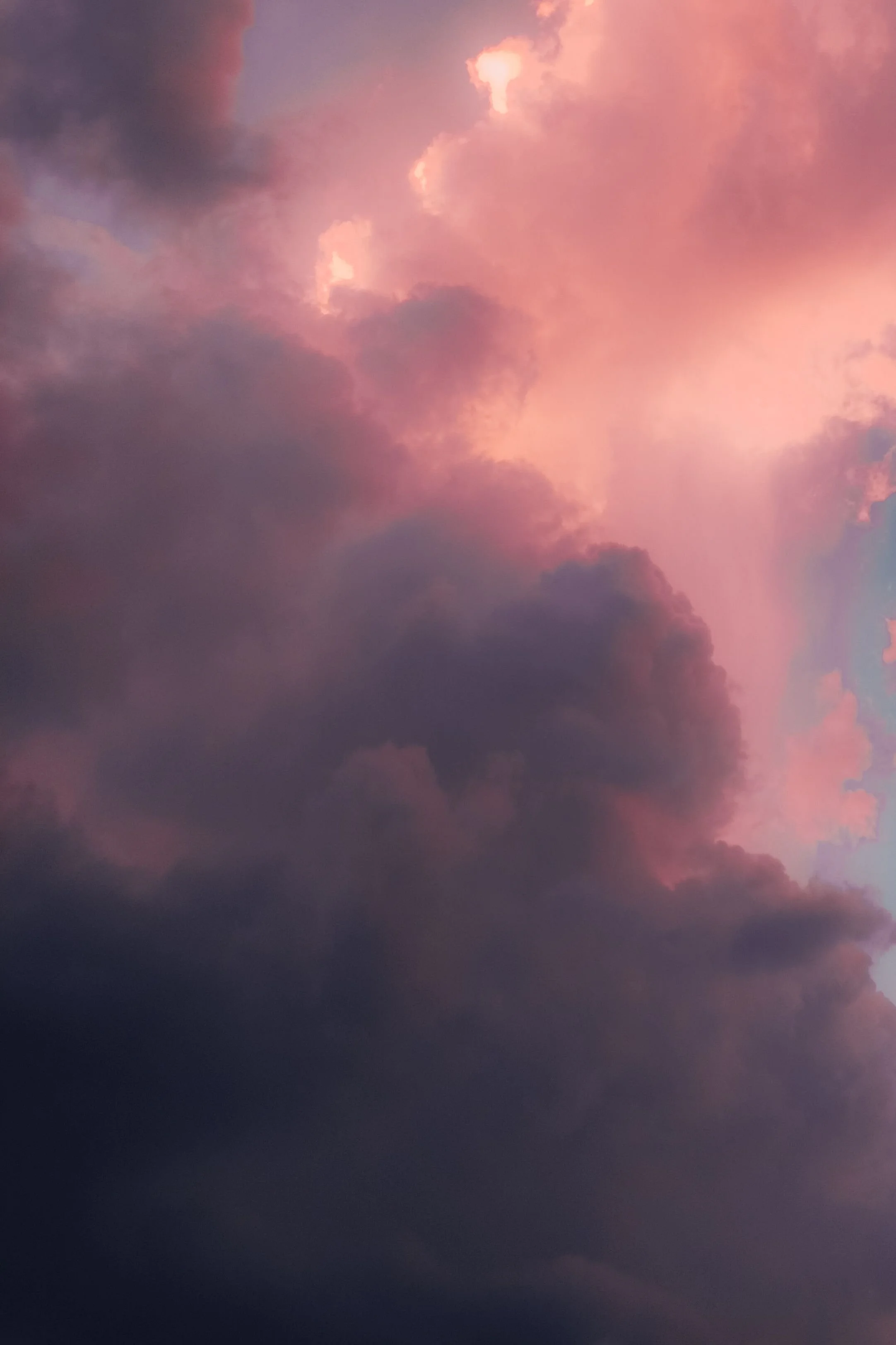 Pink and purple clouds in the sky during sunset or sunrise.