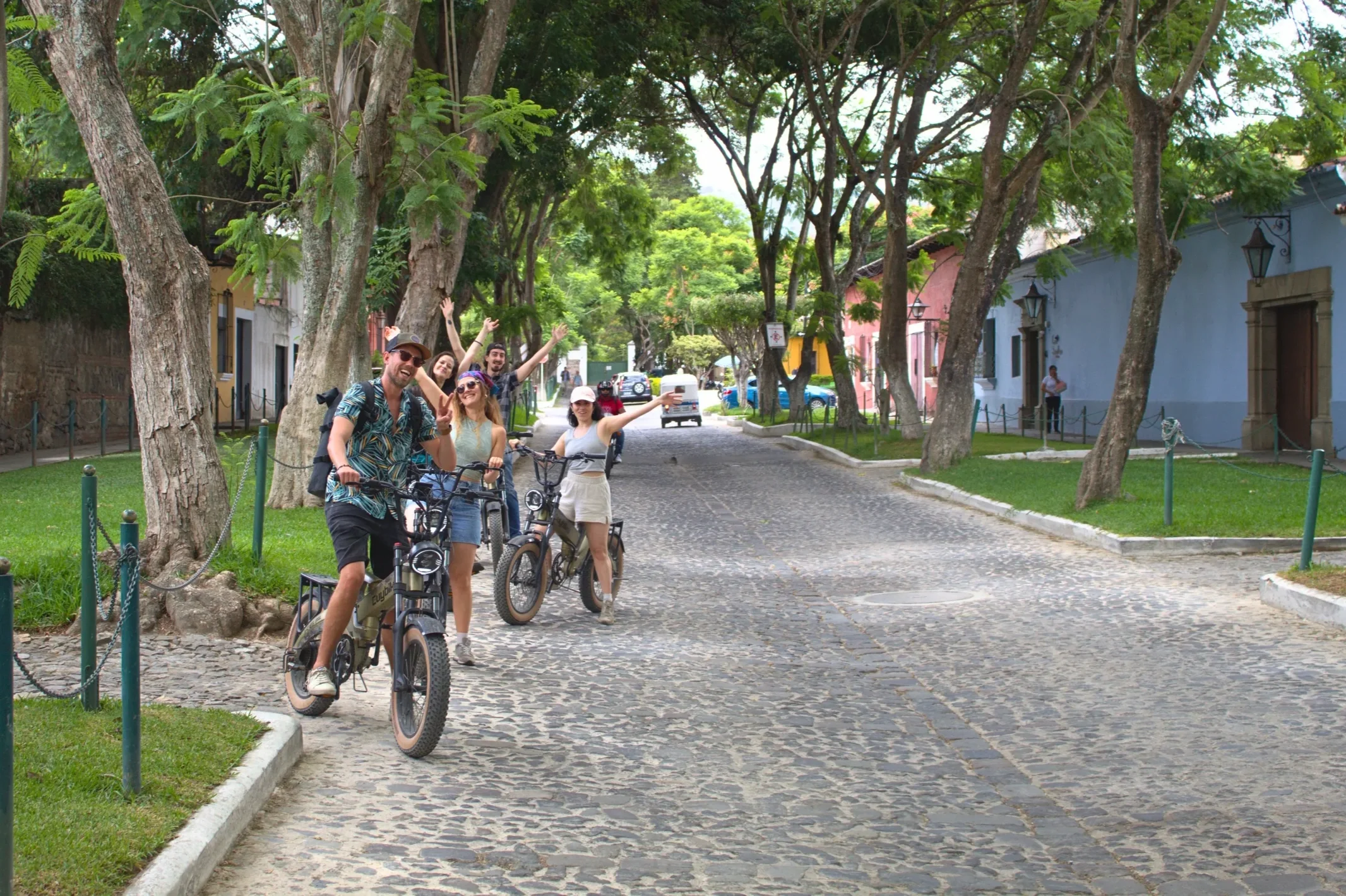 e-bike tour group in the streets of Antigua Guatemala, smiling in the camera