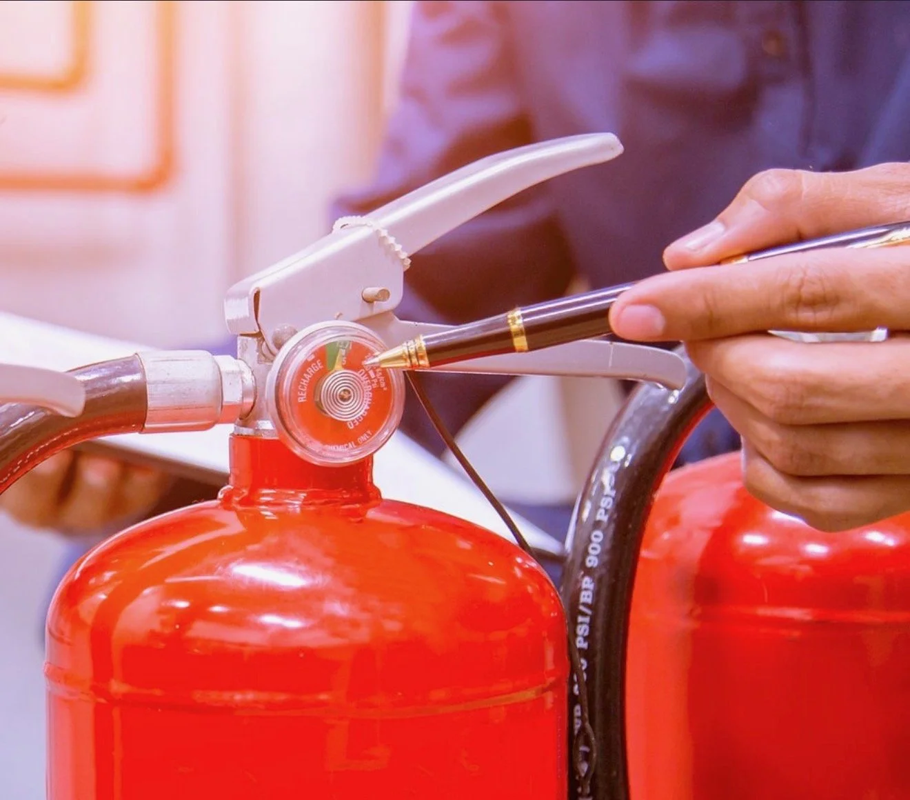 Technician servicing a portable fire extinguisher