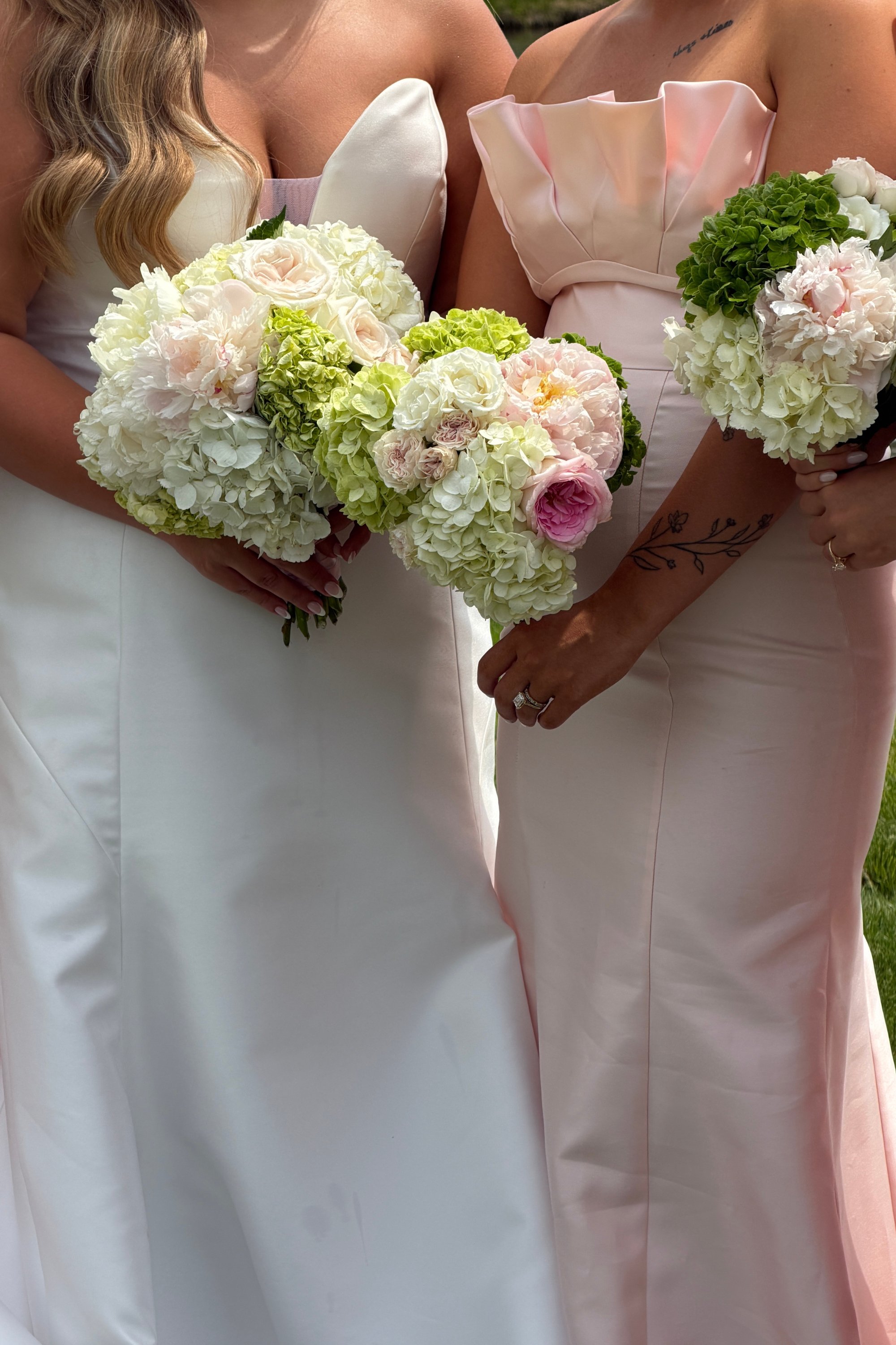 Bride next to bridesmaid in pink holding bouquets at Venue 5 Twenty Two