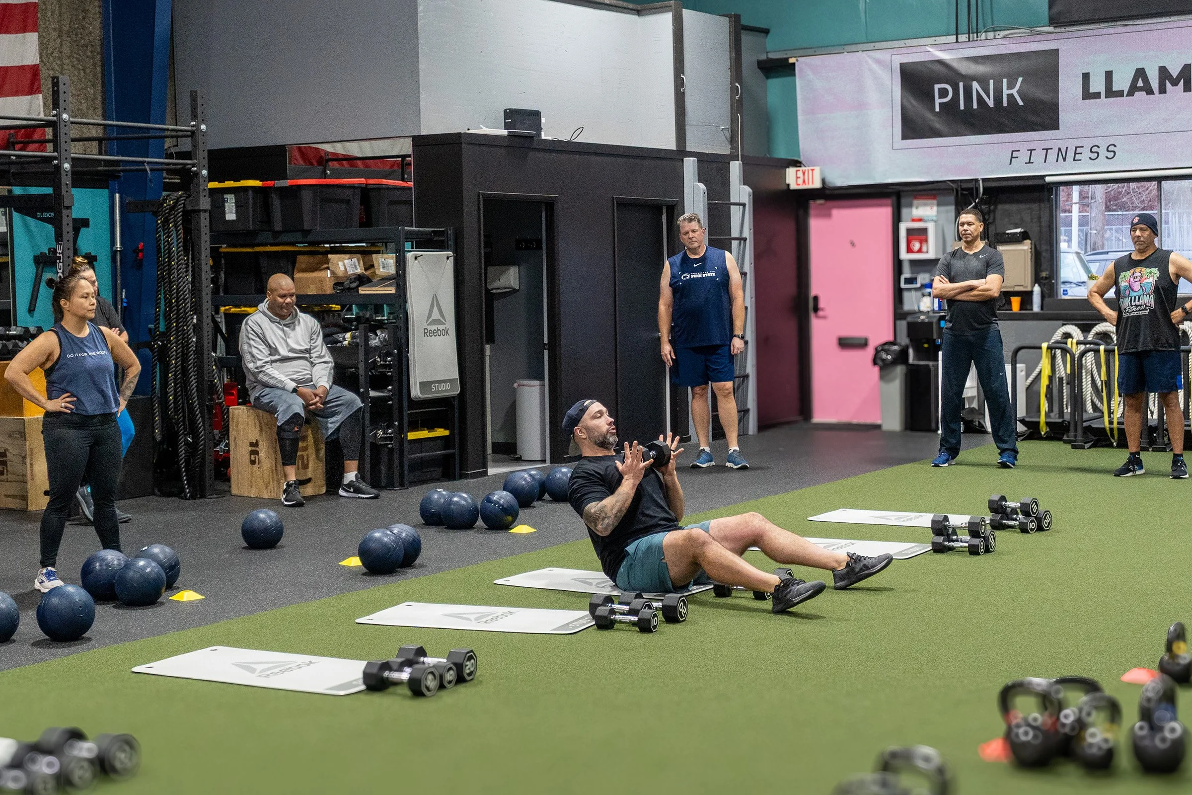 Pink Llama Fitness coach demonstrating an exercise during Group Training in Renton