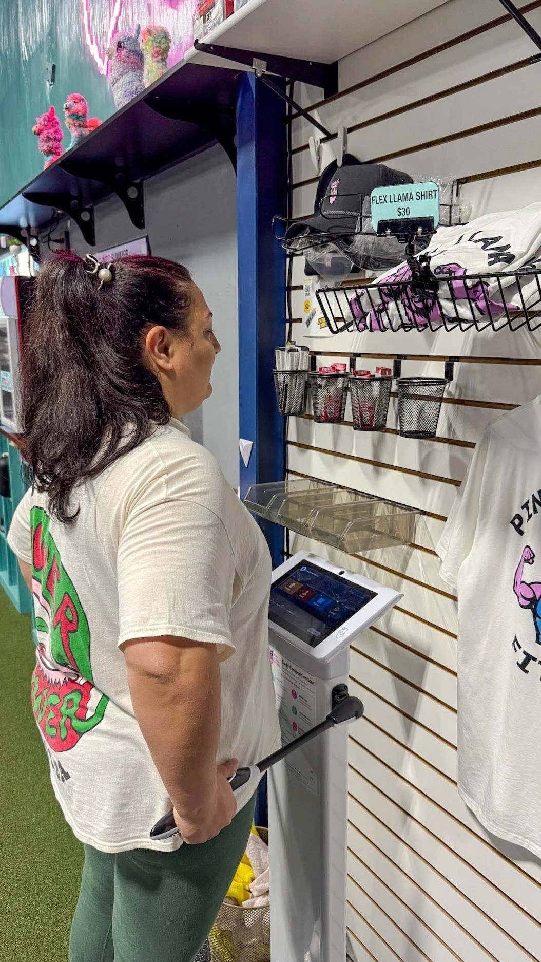 Pink Llama Fitness member completing a 3D body scan