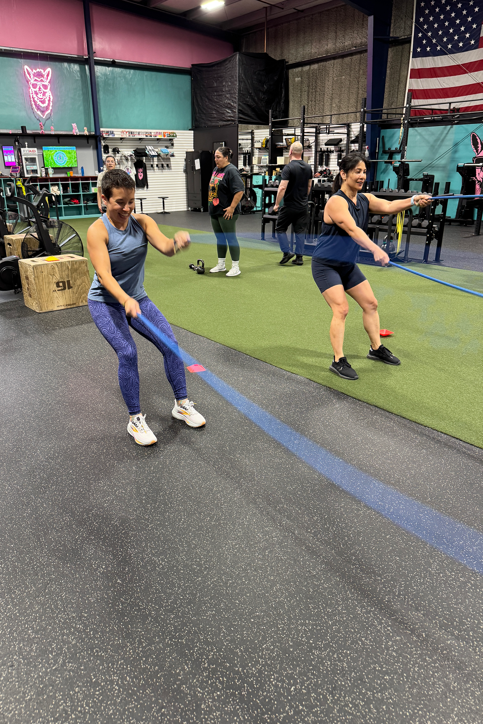Pink Llama Fitness members performing coached conditioning work