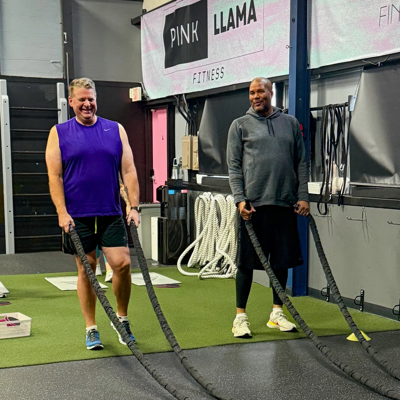 Pink Llama Fitness members training with battle ropes in Renton