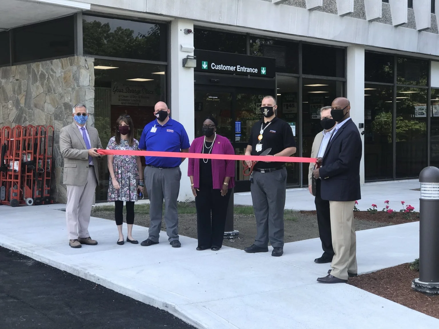 Ribbon-cutting ceremony celebrating the completed U-Haul self-storage redevelopment in Framingham, Massachusetts.
