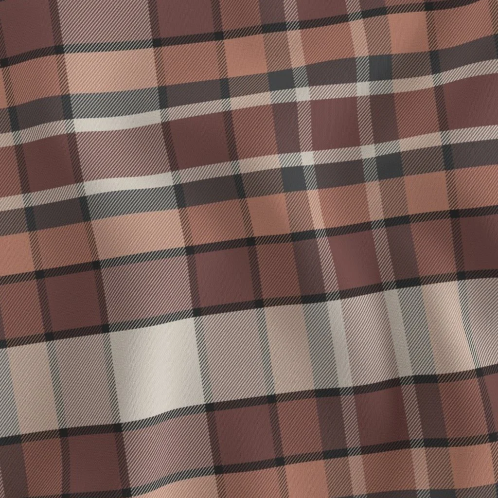 Fabric with a brown, cream, and black plaid pattern.