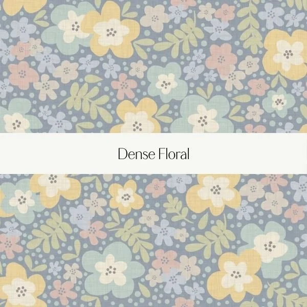 Pattern of dense floral design with pastel yellow, blue, pink, and white flowers and green leaves on a muted blue background, titled Dense Floral.