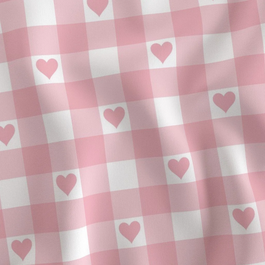 Pastel pink and white gingham check fabric featuring small solid pink hearts centered within each white square.