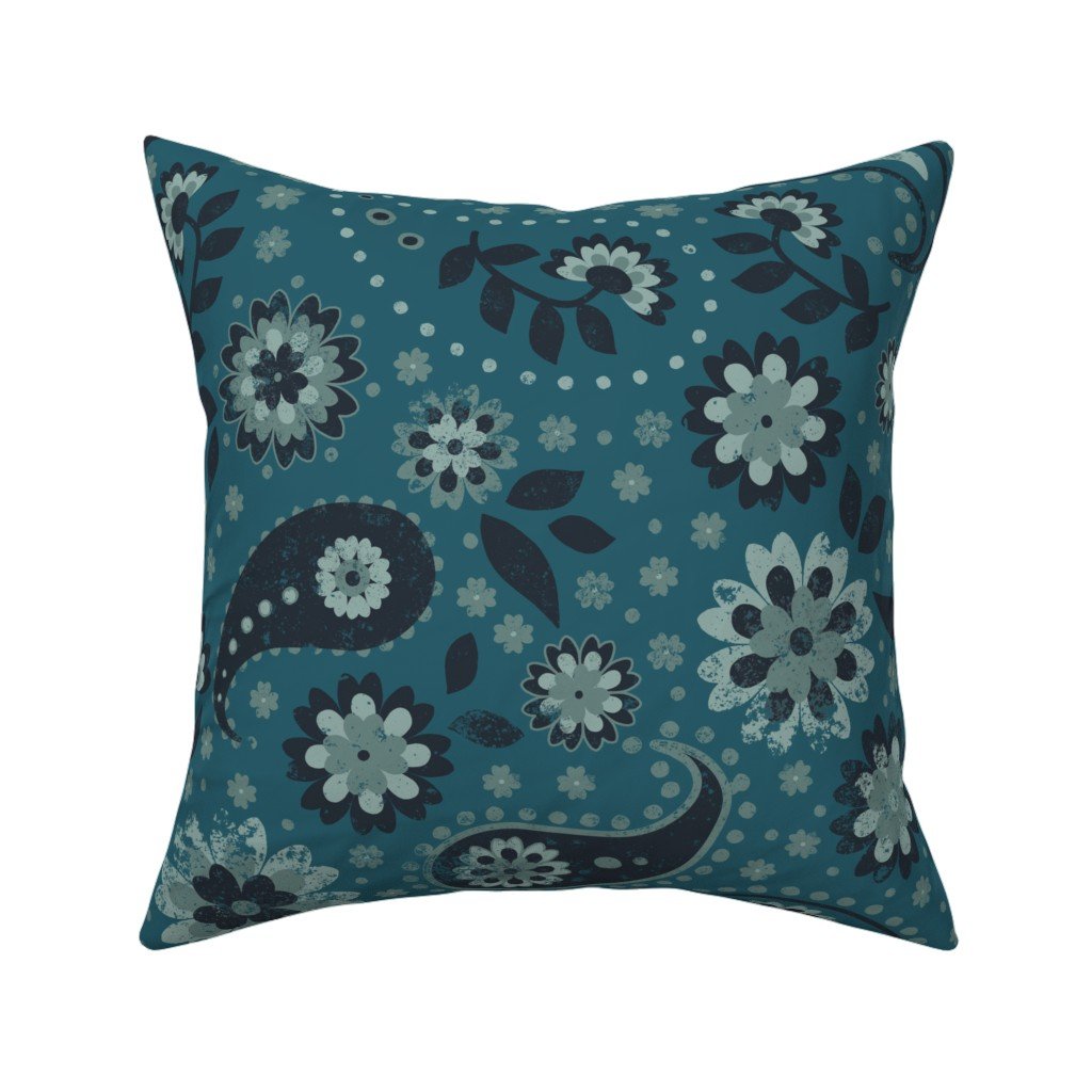 Deep teal throw pillow printed with an intricate paisley and floral motif featuring daisies and swirling teardrops in seafoam and slate blue.