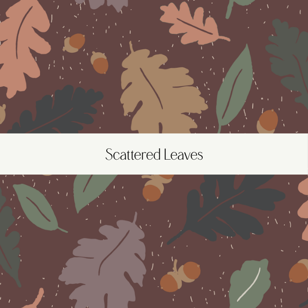 Illustration of scattered leaves and acorns on a brown background with a white band in the center reading "Scrolled Leaves."
