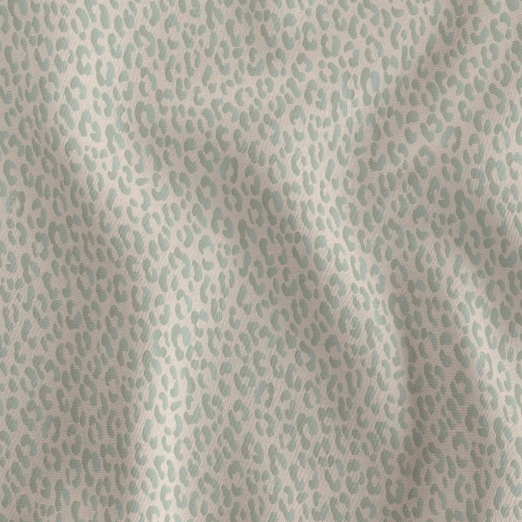 Close-up of fabric with a light blue and white leopard print pattern.