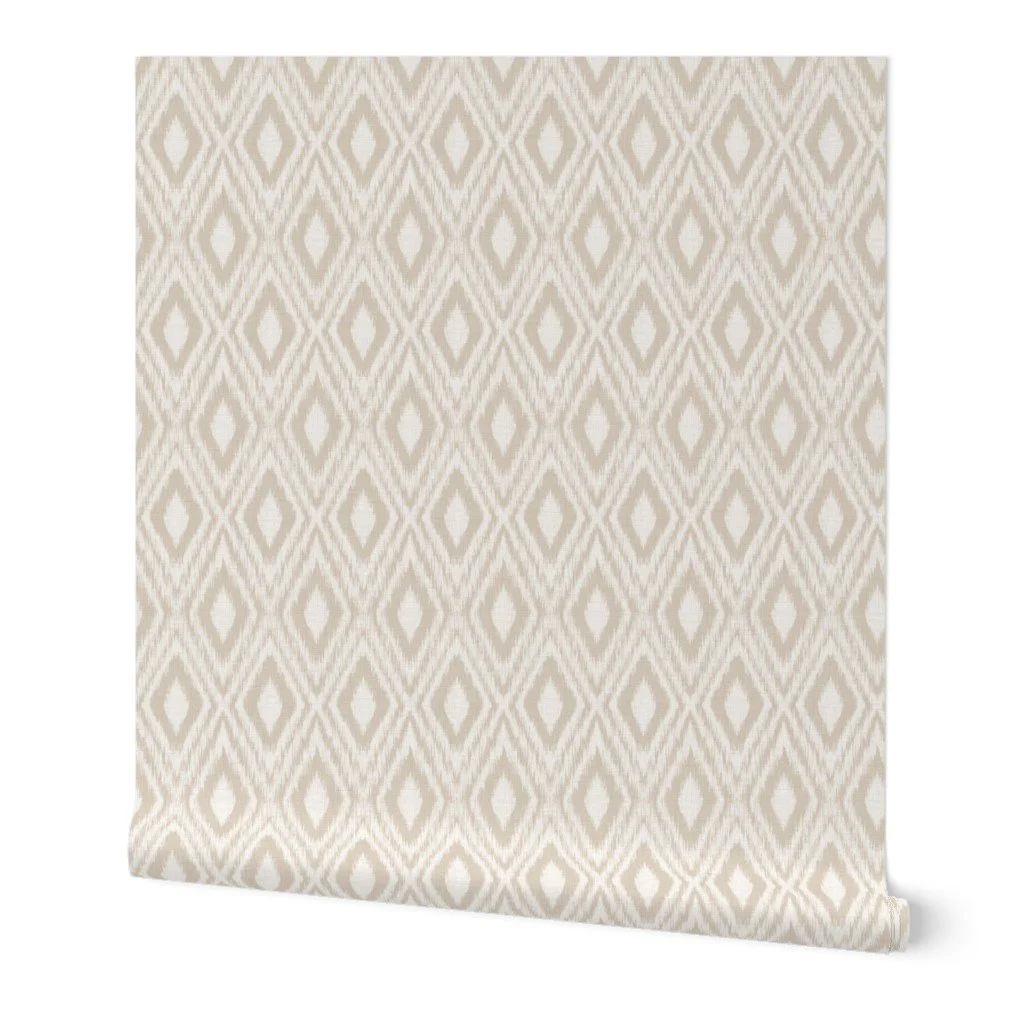Alt text: Wallpaper roll display featuring an ikat geometric diamond pattern in soft oatmeal-beige and off-white.