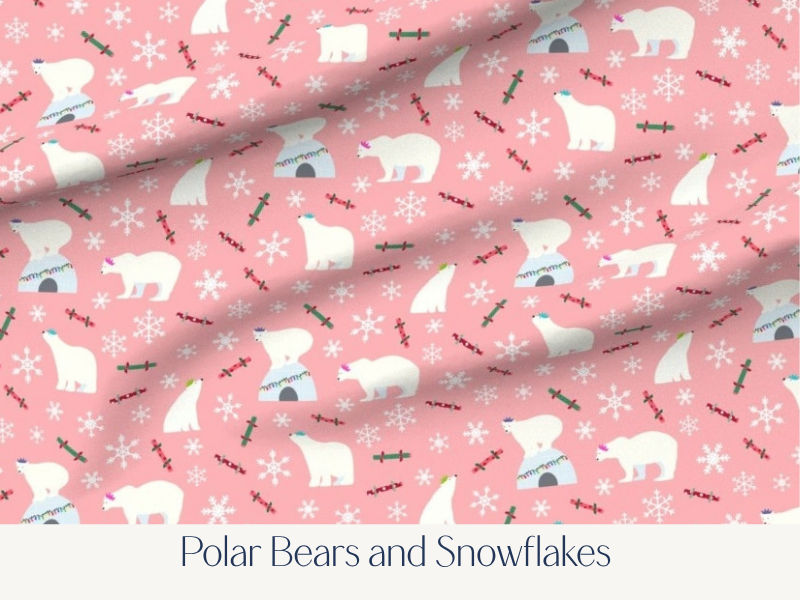 Pink fabric with polar bears, snowflakes, igloos, and holly sprigs in a repeating pattern.