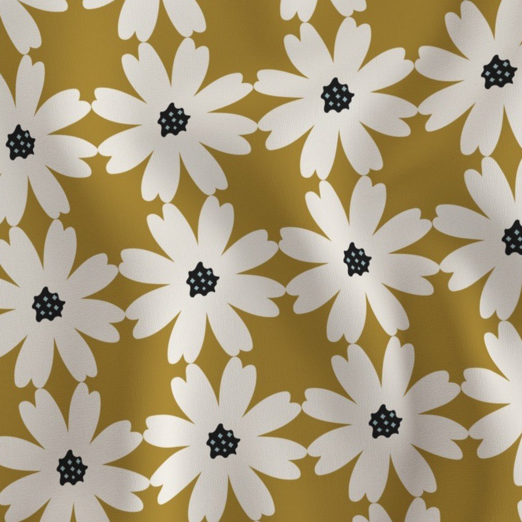 Mustard-yellow fabric with a bold retro floral pattern composed of large white daisies with textured dark navy centers.