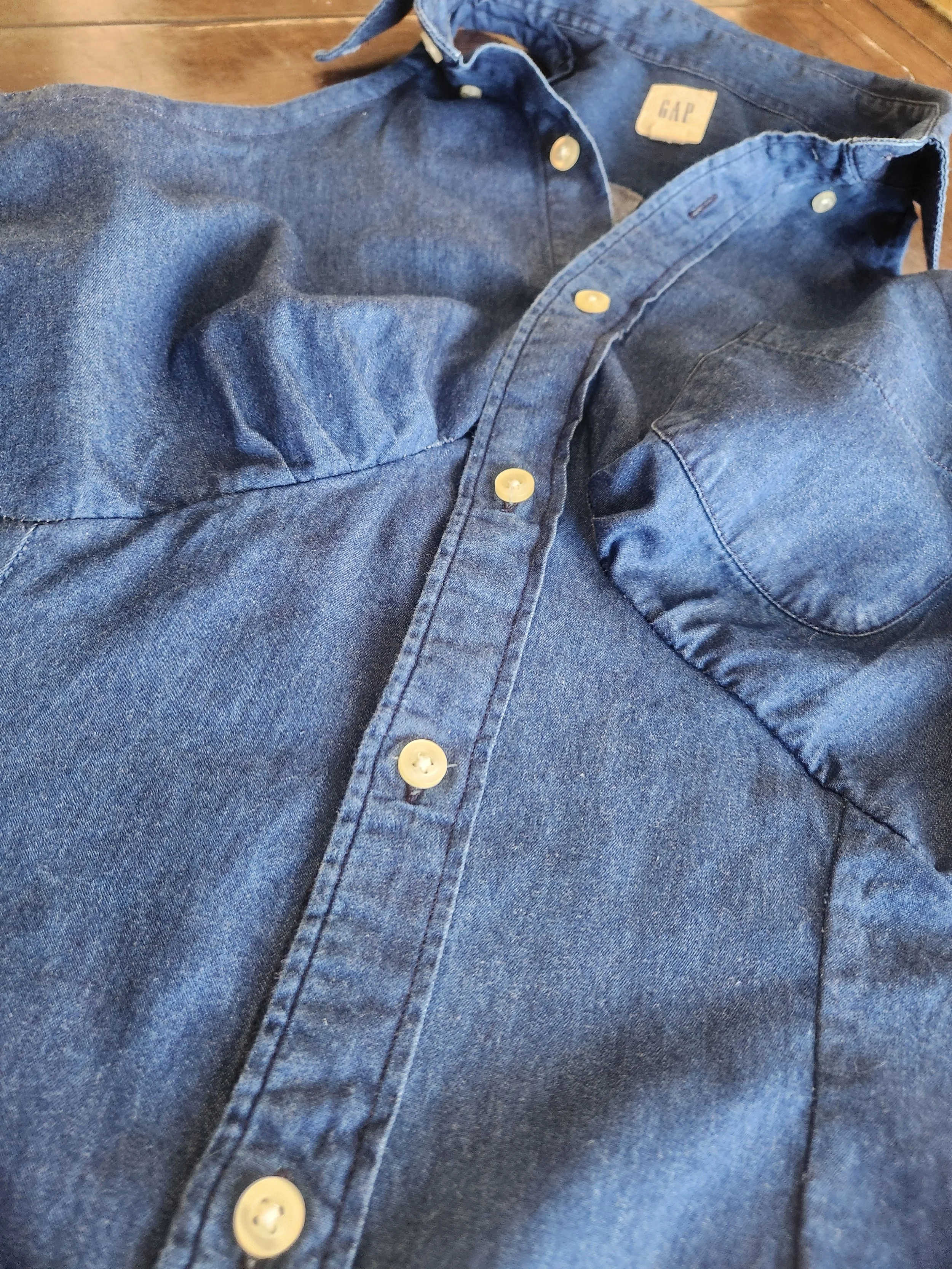 Of Character upcycled blue soft denim reimagined men's button down women's sleaveless top close up bust detail.jpg