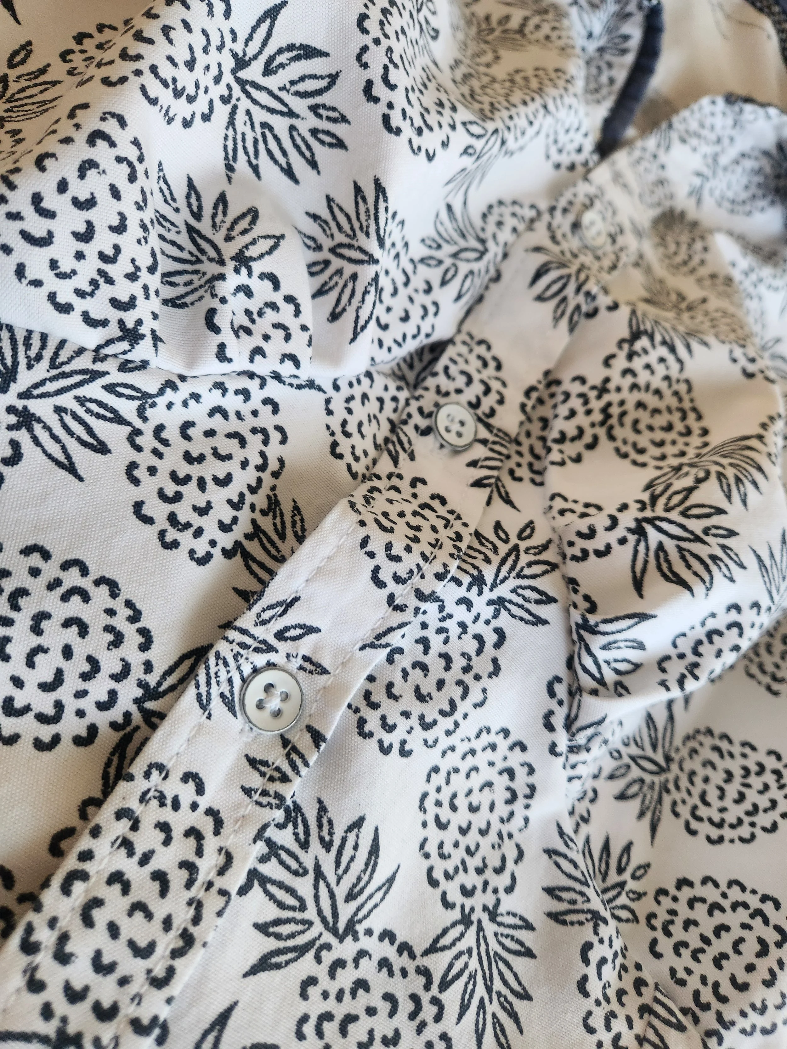 Of Character pinapples on white reimagined men's button down women's sleaveless top close up bust detail.jpg